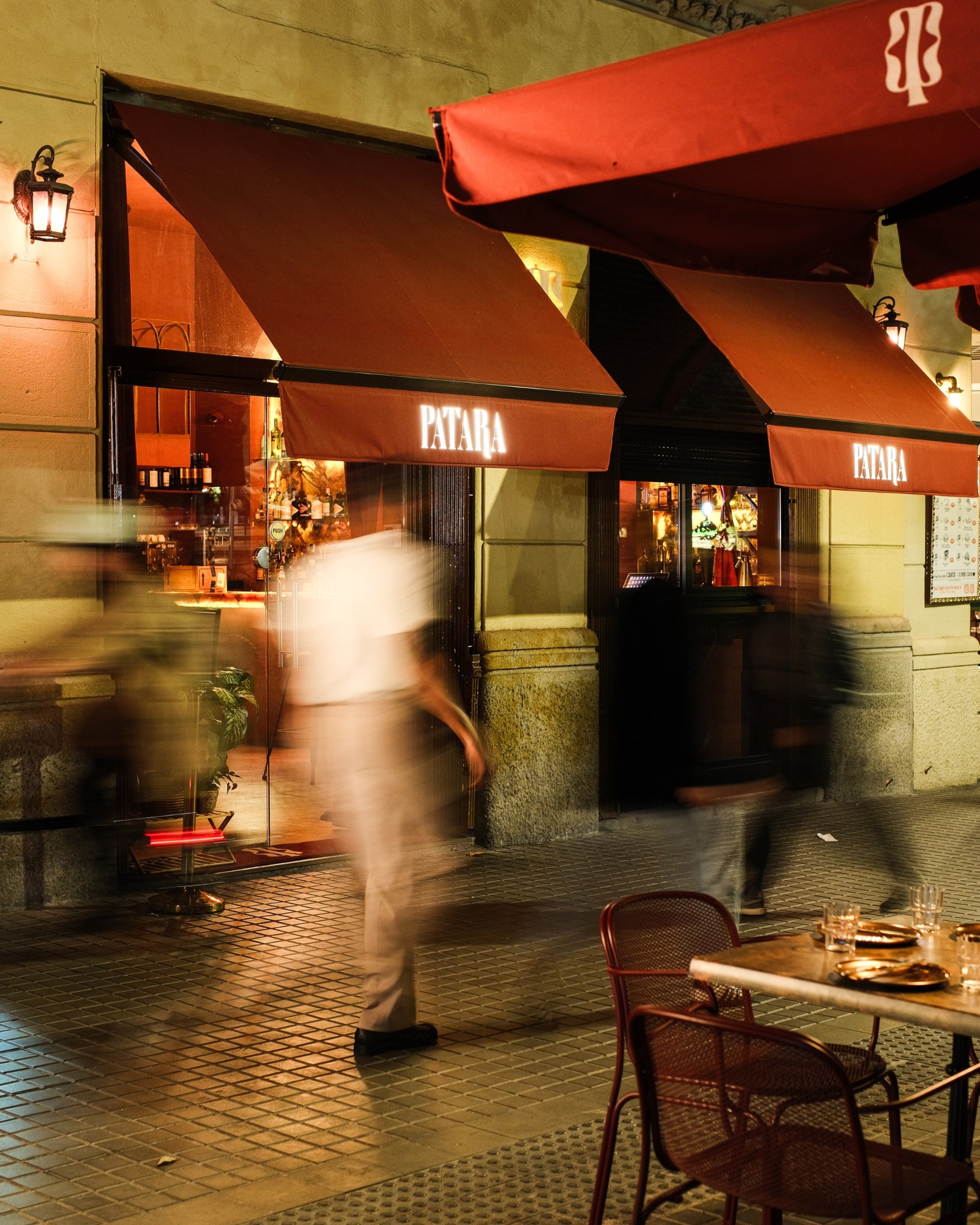 Patara bar facade at night with terracotta awnings and warm entrance light